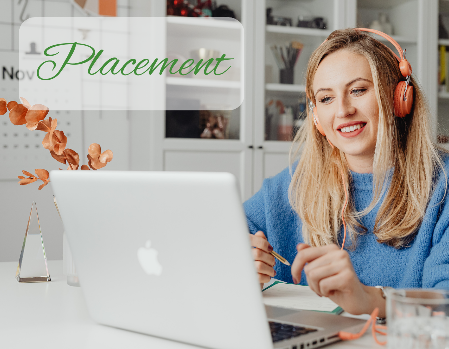 student in front of a laptop taking notes